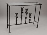 wrought iron console table with three vases on top of it