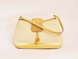 yellow and white handbag on white background