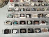 many different kinds of rocks in a display case