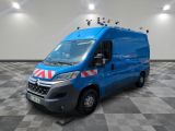 the blue van is parked on a checkered floor in a room