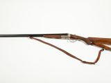 an old rifle with a wooden handle and a leather strap