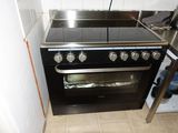 a black stove top oven sitting in a kitchen next to a counter
