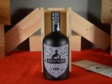 a bottle of liquor sitting on a table next to wooden crates