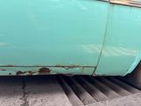 a blue car parked on the side of the road