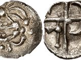 a silver coin with a cross on the front and a cross on the back