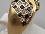 an image of a gold ring with blue and white stones