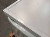 a white refrigerator sitting on top of a wooden pallet