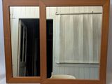 a mirror that is sitting on a table in front of a window