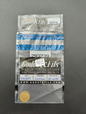 un gros plan d'une pièce de monnaie dans un sachet en plastique posé sur une table