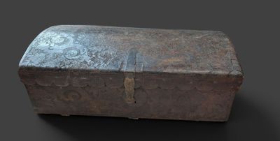 an old metal box sitting on top of a black surface
