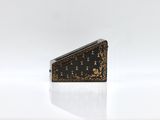 a black and gold purse with a gold design on it