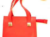 an image of a red purse with a red strap on it