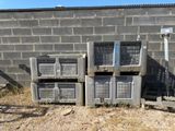 many crates stacked on top of each other in front of a brick wall