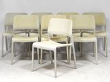 six white chairs sitting in a row on a white floor