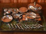 a tray with silverware on it on a wooden table