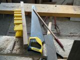 a yellow and black saw on a table next to a yellow and black tool