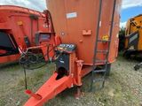 a close up of a tractor and a grainer in a field