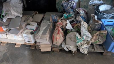 un tas d'ordures posé sur une palette dans un garage