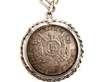 an image of a silver coin with a chain on a white background