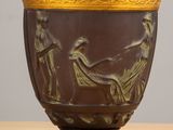 a vase that has a picture of a woman and a man on it