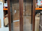 a cabinet with a glass door in the middle of a room