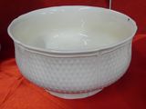 a white bowl sitting on a red table cloth
