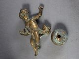a small statue of a child on a wall