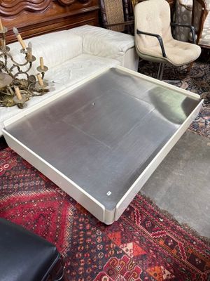 un salon avec un canapé, un fauteuil, un pouf et une table basse