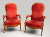 pair of red upholstered armchairs