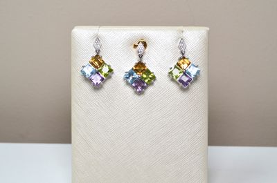 a close up of a pair of earrings on a display stand