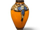 orange vase with blue and yellow designs on it