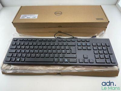 a black keyboard and a brown box on a white table