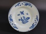 an image of a blue and white plate with flowers on it