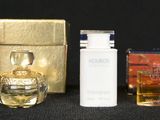 bottles of perfume and a box of perfume sitting on a table
