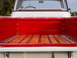 a red and white pickup truck with a wooden bed