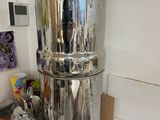 a large stainless steel water dispenser on a counter