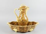 an image of a gold colored pitcher and a bowl on a table