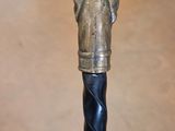 a close up of a black and gold cane on a table