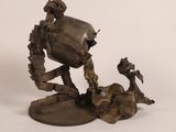 a sculpture of a robot that is on a table