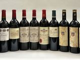 several bottles of wine are lined up on a white surface