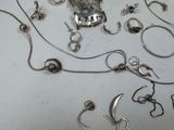 a lot of silver jewelry on a table