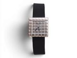 an image of a silver square watch with a black strap