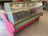 a pink and blue display case in the middle of a room