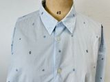 a mannequin wearing a blue and white shirt with polka dots on it