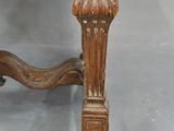 a close up of a wooden chair with a red and white upholstered seat