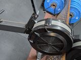 a picture of a gym equipment rack with a pair of blue and green dumbs on it