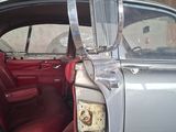 a silver car with a red seat and a mirror on the door