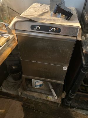 a silver dishwasher sitting on top of a counter in a kitchen