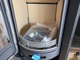 a black stove with a plastic container in it