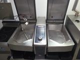 three sinks in the kitchen with a phone on them